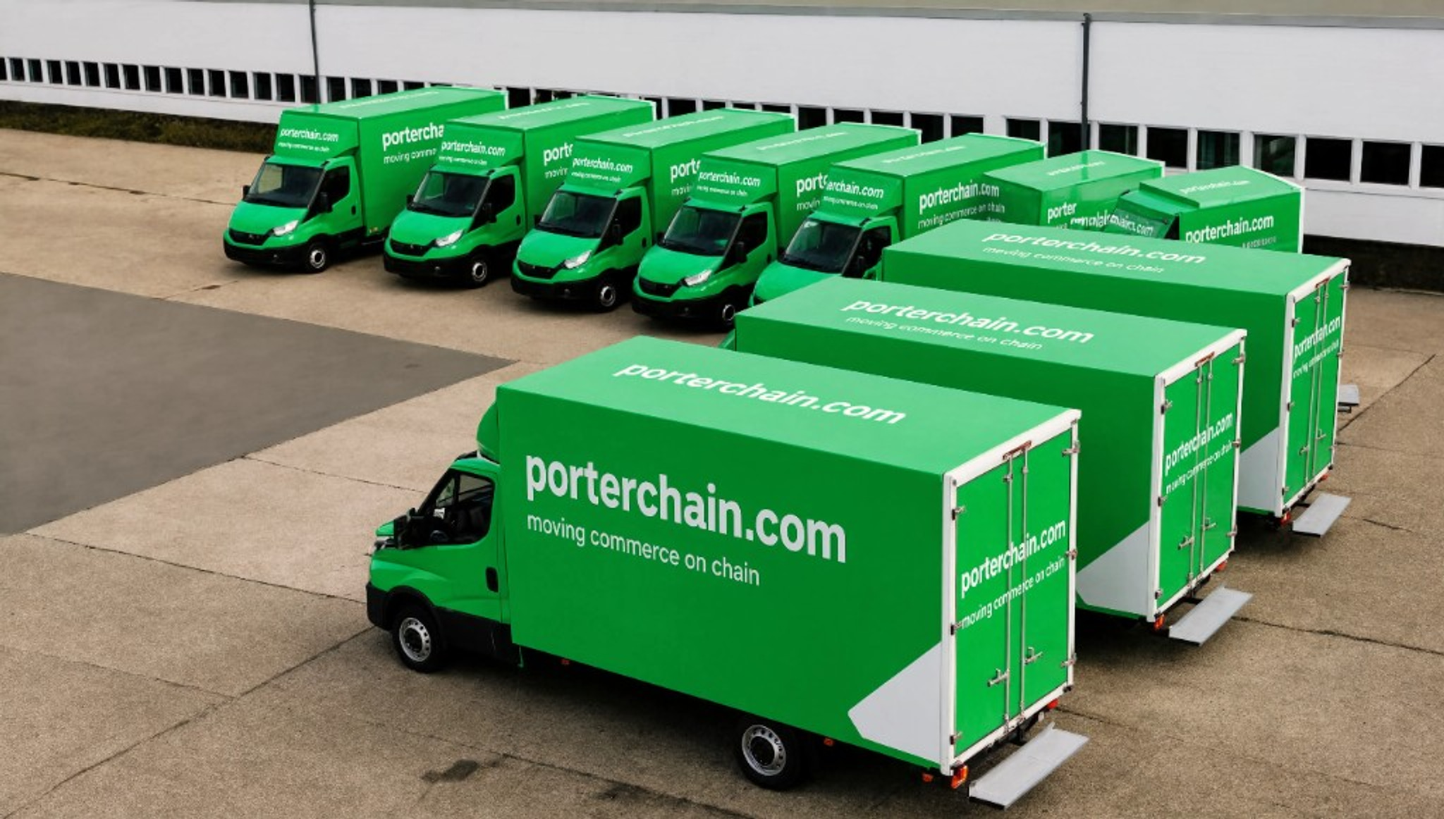 Porterchain green delivery fleet parked at the depot — moving commerce on chain